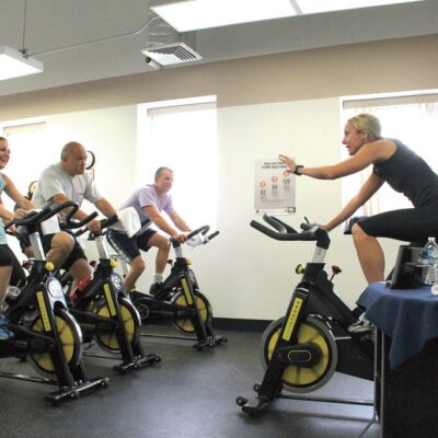 A group doing cycling in a gym