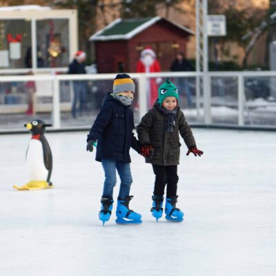 2 young children ice-skating in winter