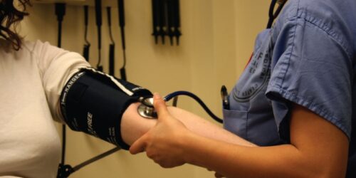 A nurse taking a blood pressure reading