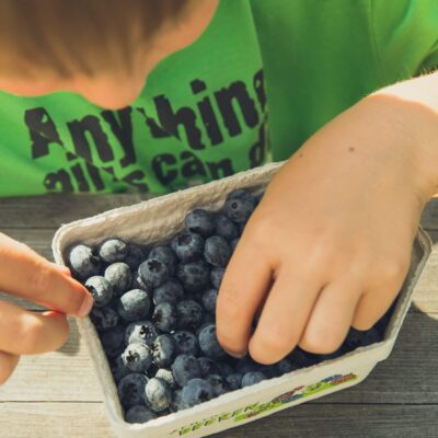 Child eating some blueberries