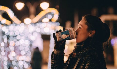 Woman drinking a hot drink at Christmas