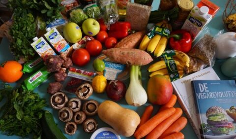A table full of vegan foods like vegetables and fruits