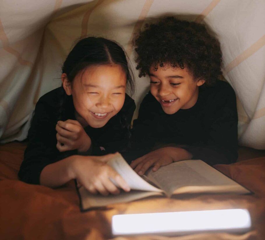 Siblings reading a book together