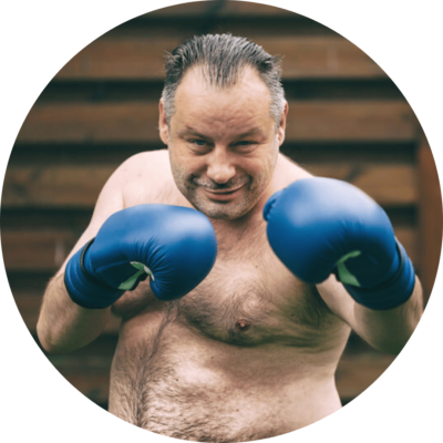 Overweight middle aged man boxing