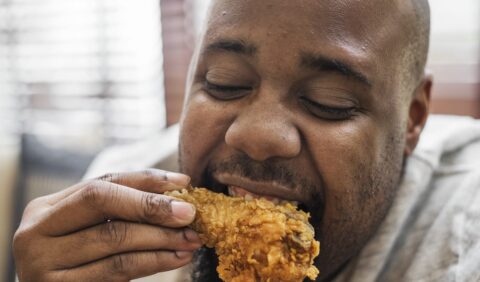 Man eating fried chicken