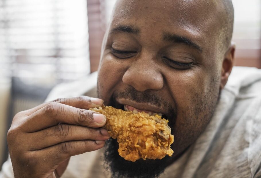 Man eating fried chicken