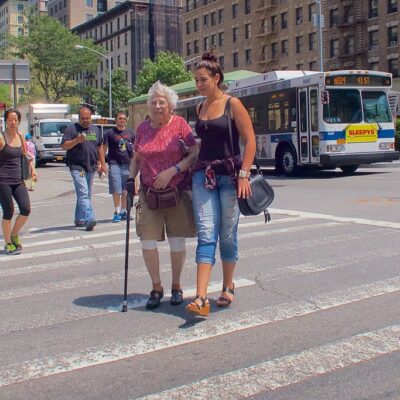 Woman taking older woman on a walk