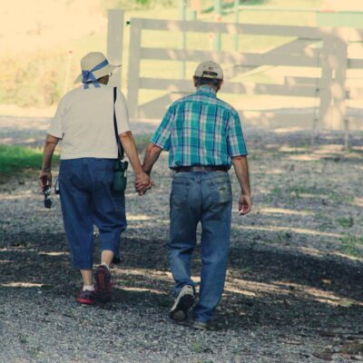 Older couple walking while holding hands