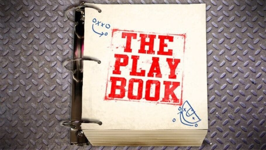 A stack of paper with 'The Play Book' written on the front