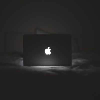 Apple laptop lit up at night