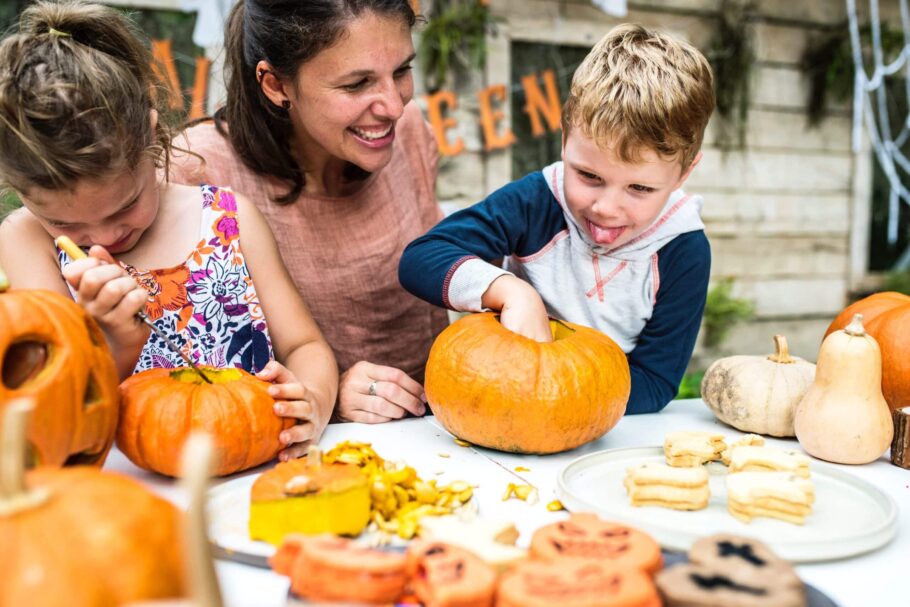 Mother and children carving pumpkins