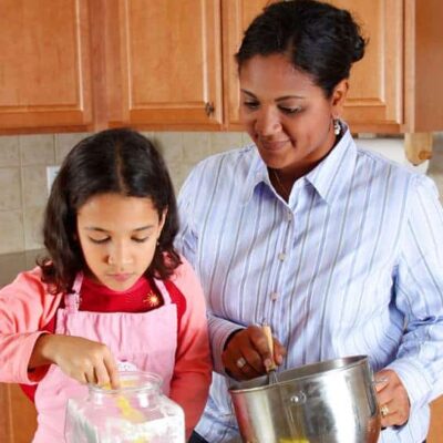 A mother and daughter baking at home