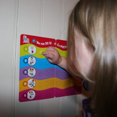A child filling in a non-food reward chart on a door in their house