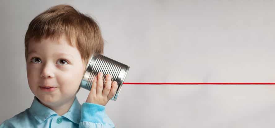 Boy communicating with tin can phone
