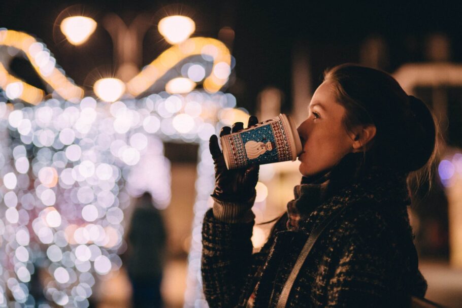 Woman drinking a hot drink at Christmas