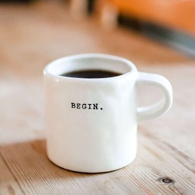 Coffee mug with the word begin on it