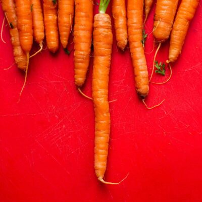 Bunches on carrot on a red background