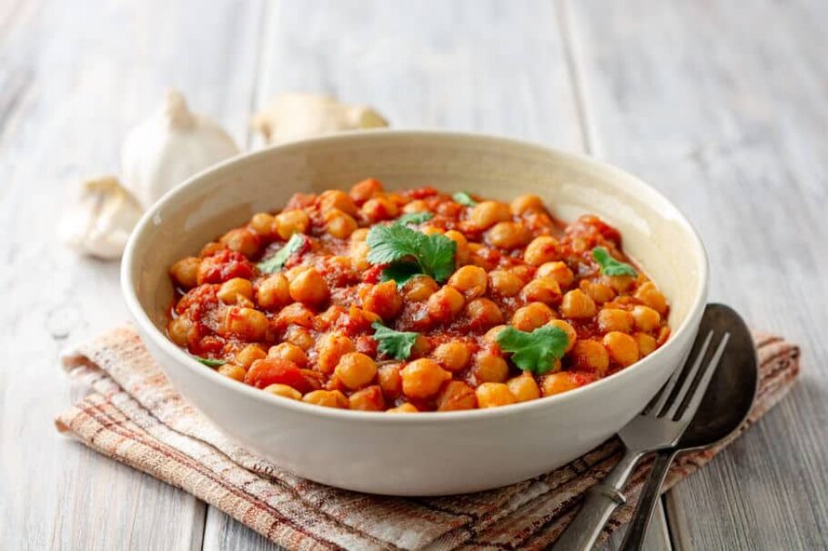 Spicy Chickpea curry Chana Masala in bowl on wooden table