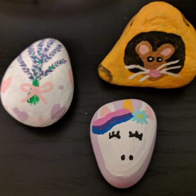 Painted rocks with a unicorn, mouse and tree