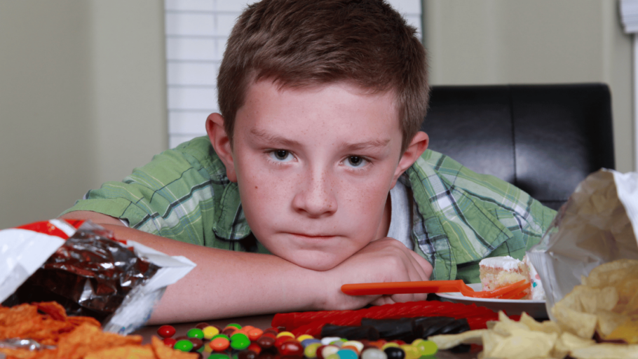 Boy staring at sweets and chocolate