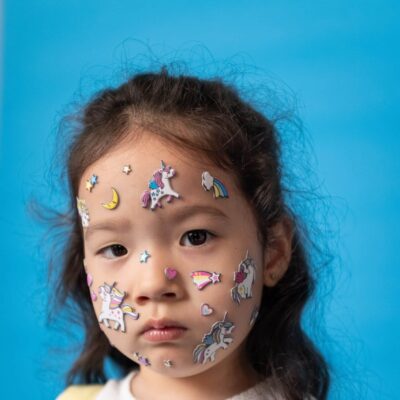 Child wearing stickers on her face
